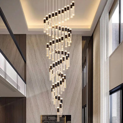A modern crystal chandelier with cascading clear textured glass cylinders black caps and warm LED lights