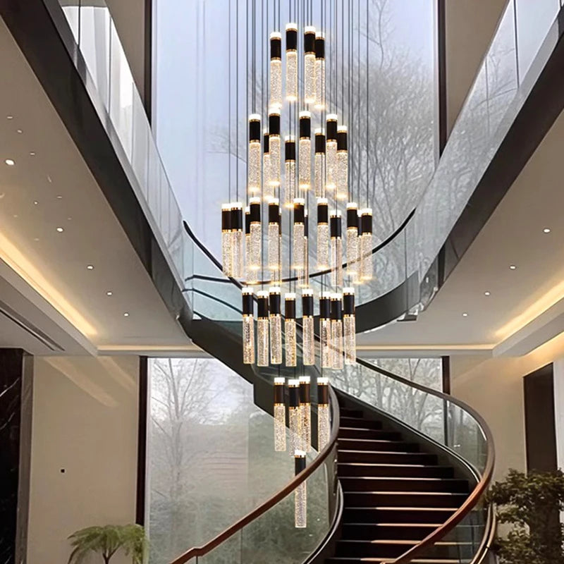 Modern crystal chandelier with cascading cylindrical glass tubes capped in black and warm led lights inside