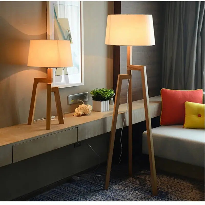 Table lamp and floor lamp with beige shades beside a sofa